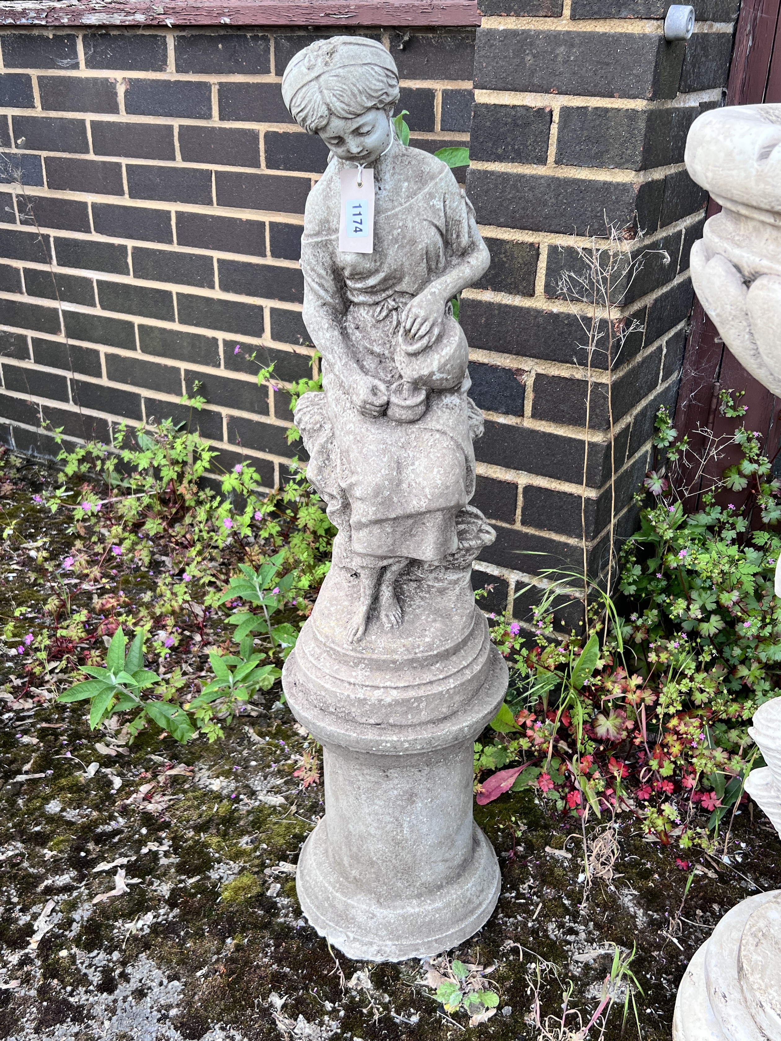 A reconstituted stone garden statue of a water girl, height 94cm